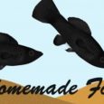 An Animated Image Of Two Black Fish Eating Fish Food - Homemade Fish Food Concept.